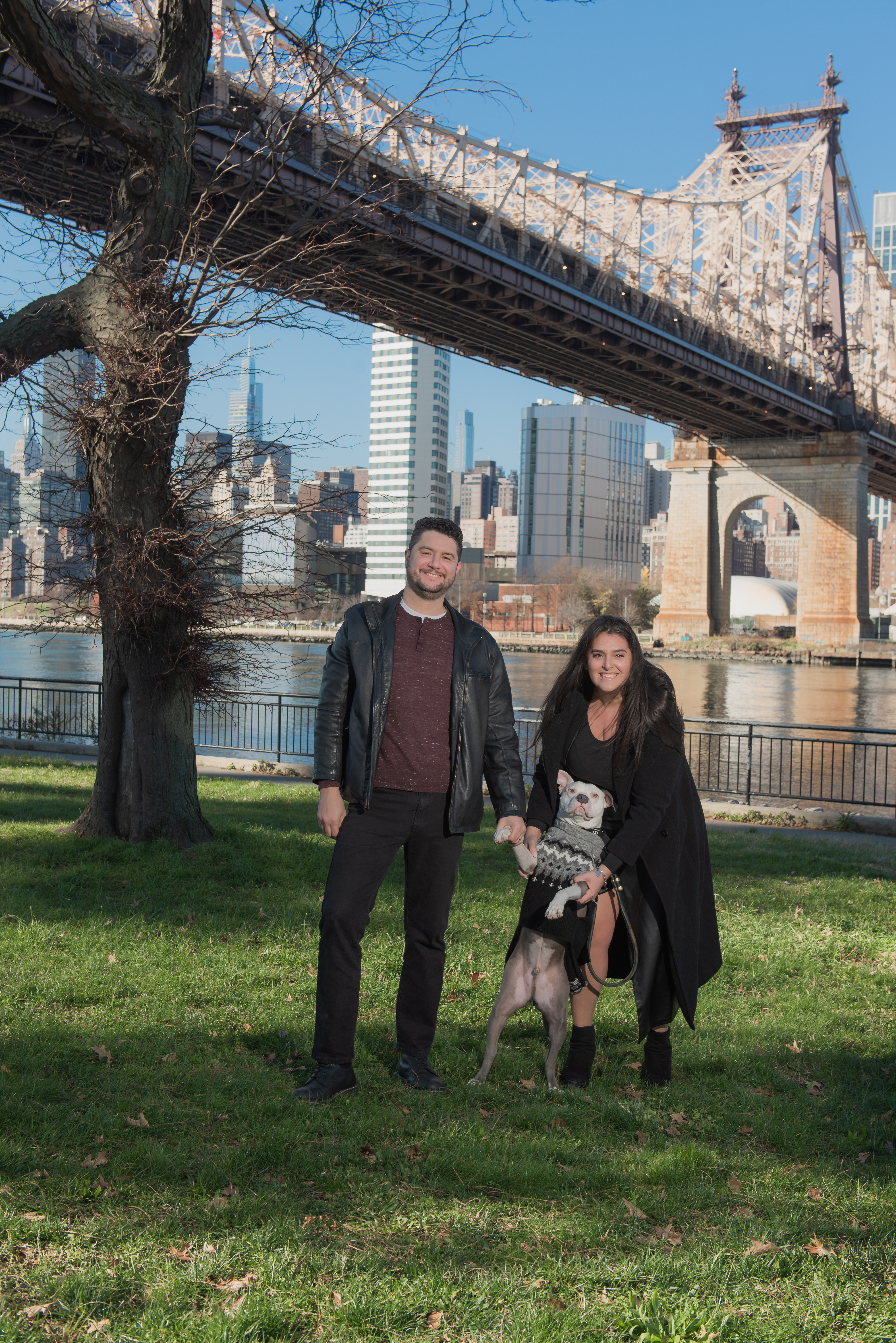 Caryn, her husband, and Shrimp the deaf dog in front of the Queensboro Bridge, Queens New York